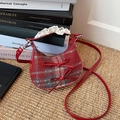Red plaid crescent crossbody bag with mini bows and lace trim on a woven mat - Red Checkered