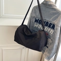 Large black lightweight travel bag with adjustable strap over blue denim jacket - Black