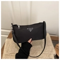 Classic black nylon baguette bag featuring silver triangle logo and zipper closure - Black