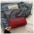 Minimalist red nylon baguette underarm bag with a vintage triangular metal logo plaque - Red