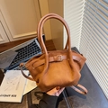 Brown suede tote bag with leather handles and gold buckle in a modern lifestyle setting - Brown