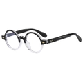 Retro oval black and clear frame glasses with gold wing accents shown from a 45-degree angle - Transparent and Black