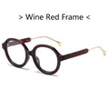 Occhiali anti-luce blu tondi futuristici con montatura bordeaux e stanghette dorate - Montatura rosso vino
