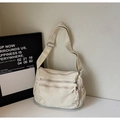 Detailed macro view of the three zipper pockets and canvas texture on a white tote bag - Off White