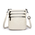 Cream white crossbody bucket bag with embossed camellia flowers and triple front zippers - Off White