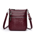 Deep burgundy leather crossbody bag with embossed rose pattern and triple zipper pockets - Burgundy