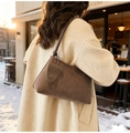 Detail of dark brown suede shoulder bag with mini pouch charm in a cozy outdoor setting - With Small Pouch / 88813 Khaki