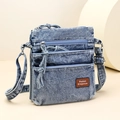 Light blue washed denim crossbody bag with three zipper compartments and shoulder strap - Blue