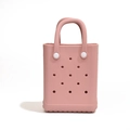 Pink EVA mini beach bag with perforated holes and white strap handles in 45-degree view - No Accessories / Pink