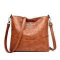 Brown vintage faux leather bucket bag featuring embossed clover patterns and silver logo - Yellow
