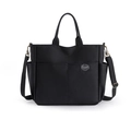 Große schwarze Canvas-Reisetasche mit zwei Fronttaschen und verstellbarem Schultergurt - Schwarz