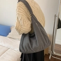 Deep grey oversized hobo bag in soft plush texture for winter style shown on model - Gray