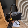 Black Boston bag with patent leather contrast and decorative tassels and a bow - Black With Pendant