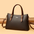 Deep brown woven tote bag with leather handles and metallic hardware details - Brown
