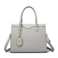 Detailed macro of grey lychee leather texture with gold lettering on a tote handbag - Gray