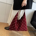Chic burgundy studded hobo shoulder bag shown on model with minimalist modern styling - Burgundy