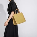 Minimalist yellow canvas tote bag with brown leather handles and adjustable shoulder strap - Yellow