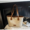 Detail of beige tote bag with dark brown leather straps and branded patch on white surface - Beige Without Pendant