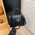 Retro black matte shoulder bag with gold twist lock and contrast stitching detail - Black