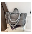 Detailed view of grey puffer tote bag featuring quilted nylon and padded handles - Dark Gray