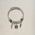 Silver steel cable bracelet featuring green beads, clover, and wing charms with LOVE bead - Green Wing Clover Bracelet