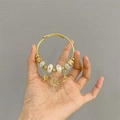 Golden coil bracelet with star and moon charms featuring white enamel beads and crystals - Wonderland Star Moon Bracelet