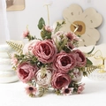Close-up of pink and cream faux peonies with green leaves in a home decor setting - Pink
