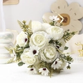 Detailed view of artificial white roses and daisies with lush green fern leaves for decor - Cream