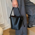 Elegant black lychee leather bucket bag with top handle and stylish side drawstring straps - Black
