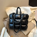 Quilted black puffer tote bag in glossy nylon featuring a puffy square-stitched design - Black