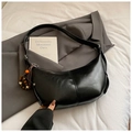 Detail of black semi-circle hobo bag in glossy leather with wooden bead decorative charm - With Pendant / Black