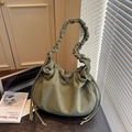 Detailed macro view of sage green corduroy bag with pleated handle and drawstring design - Green