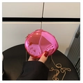 Mini hot pink evening bag with metallic finish and gold chain strap held by hand - Pink