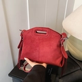 Red matte suede shoulder bag with elegant fringe tassels and top handle design - Red