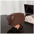 Close-up of caramel brown suede crossbody bag with adjustable leather strap and metal buckle - Brown