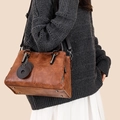 Retro dark brown leather tote bag with vintage texture and circular charm detail - Yellow Brown