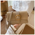 Detail of minimalist beige leather crossbody bag featuring gold horseshoe buckle and suede - Khaki