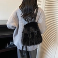 Close-up of black faux fur drawstring backpack with soft texture and fabric straps - Black