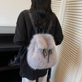 Detail of grey faux fur backpack showing dense texture and sleek black shoulder straps - Light Gray