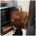 Detail of dark brown vintage backpack featuring leather texture and golden twist lock closure - Brown