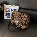 Stylish leopard print chain crossbody bag with a golden turn-lock closure on black leather - Brown