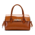 Vintage brown leather tote bag with woven handles and silver twist lock on white background - Caramel color