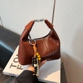 Brown woven leather handbag featuring a vintage metal top handle and colorful wood beads - Brown with Pendant