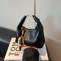 Black woven leather hobo handbag with a beaded tassel and silver metallic hardware - Black With Pendant