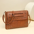 Brown rivet studded crossbody envelope bag with silver hardware and leather texture - Brown