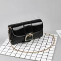 Glossy black patent leather flap bag with gold D-buckle and metal chain strap - Black