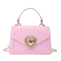 Pink patent leather crossbody bag with vintage gold heart pearl buckle on white background - Pink