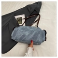 Detail of light blue denim bag featuring silver protective rivets and brown leather strap - With Pendant / Denim Blue
