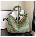 Detail of green plaid tote bag with pleated handles and drawstring cloud texture - Green/Yellow Plaid