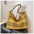 Detailed view of yellow plaid shoulder bag with ruched drawstring strap and bow accents - Yellow Brown Plaid